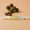TROOTH beauty cuticle and nail oil with castor oil seeds and plants on a beige background