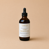 TROOTH beauty jamaican black castor hair growth oil bottle on a beige background